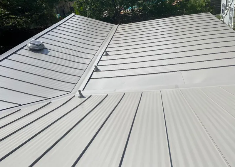 Solar attic fan installed on a metal roof for Roof Ventilation in Raytown